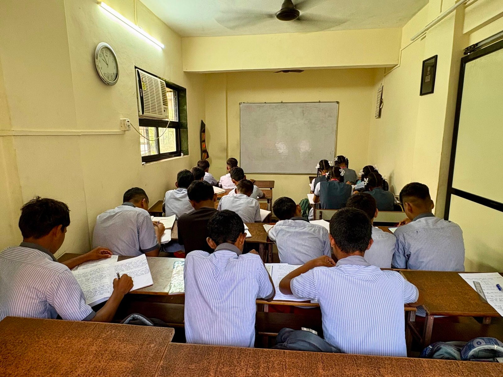 Students writing notes during a lecture at Success Educare Classes Neral – 10th and 11th 12th Commerce coaching